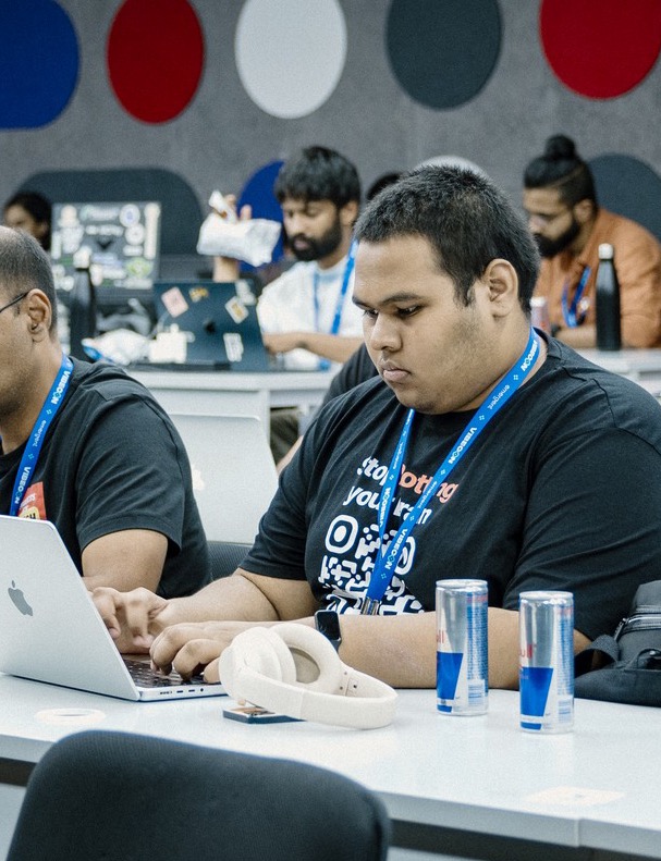 Parshva Gala working on a laptop at Vibecon